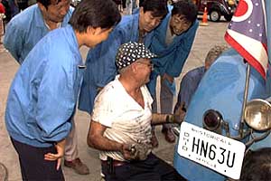 Chic Kleptz and a team of recruits work on the 
Marmon.