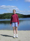 Nancy on the beach. Swimming area behind her.