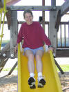 Nancy can't pass up a playground slide!
