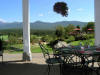 Outdoor dining area with view of mountains, golf course and tennis courts