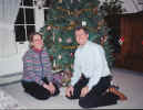 Nancy and Ken in front of their Christmas tree in their Needham, MA home.
