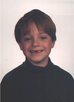 First grade, ready to be a movie star!  Singing all I want for Christmas is my two front teeth!! September 1997