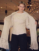 Woman modeling white fringed shawl