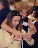 Woman teaching another woman to knit